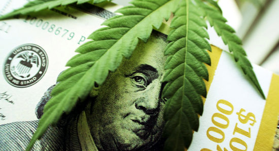 Cannabis leaf over cash