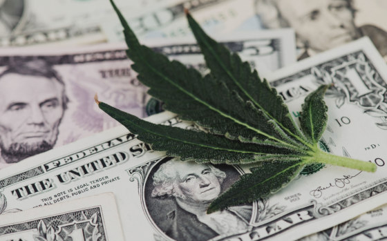 cannabis leaf on U.S. cash