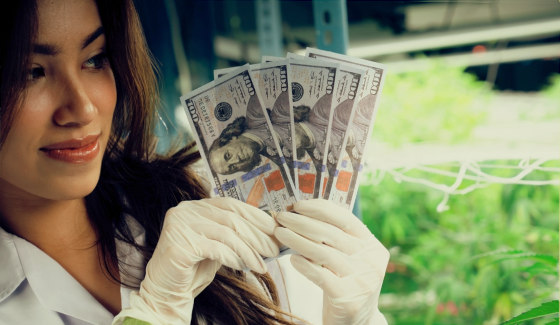 woman holding money at cannabis facility