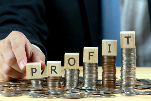 profit letter blocks stacked on coins